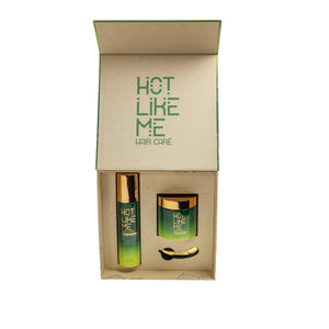 A haircare kit presented in a box with the brand name 'Hot Like Me'. The kit includes a spray bottle and a jar, both with green labels and gold accents.