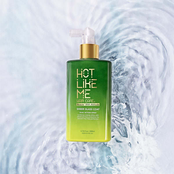 Sheer Glass Coat Bottle by Hot Like Me Haircare sitting in water