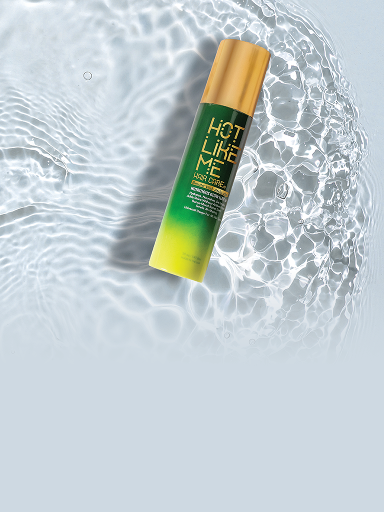 Hot Like Me Nutritious Glow Leave In Spray Bottle sitting in clear, refreshing pool of water
