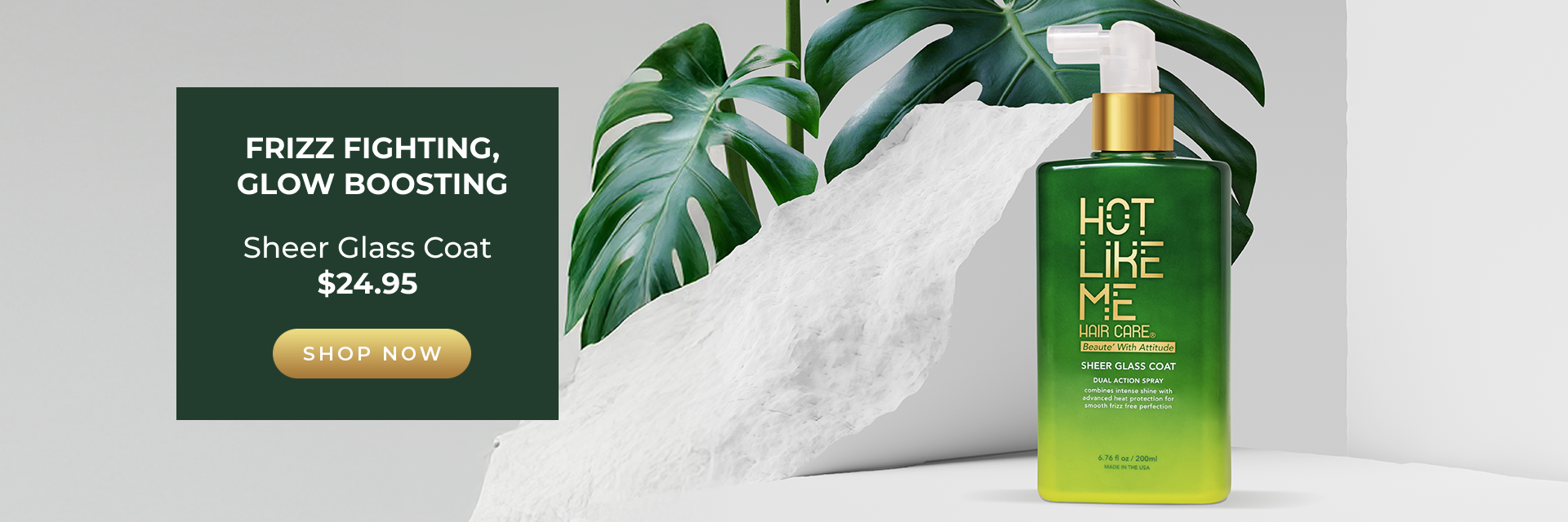 Hot Like Me Hair Care's Sheer Glass Coat bottle sitting on a marble ledge with a graphic next to it that says "Frizz Fighting, Glow Boosting. Sheer Glass Coat, Shop Now" 